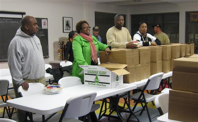 Ms. E. Denise Smith, church member and our Board Vice President, presents the
Thanksgiving food boxes to our residents.
 